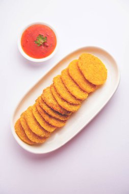 crispy potato rava fried slices or batatyache kaap or batata semolina fry snacks from India