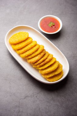 crispy potato rava fried slices or batatyache kaap or batata semolina fry snacks from India