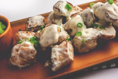 vegetarian soya malai chap made using soya chaap with white creamy gravy