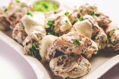 vegetarian soya malai chap made using soya chaap with white creamy gravy