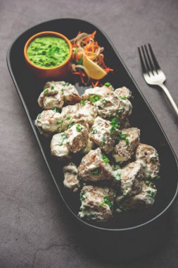 vegetarian soya malai chap made using soya chaap with white creamy gravy