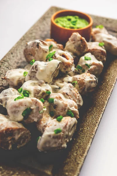 vegetarian soya malai chap made using soya chaap with white creamy gravy