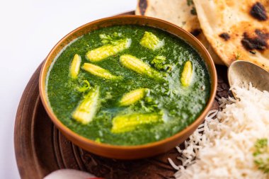 palak baby corn sabzi also known as spinach makai curry served with rice or roti, Indian food