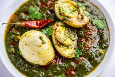 Spinach egg curry is an Indian non vegetarian dish made using palak gravy with eggs