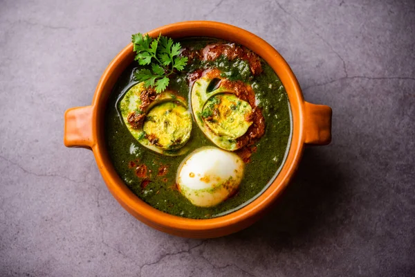 Spinach egg curry is an Indian non vegetarian dish made using palak gravy with eggs