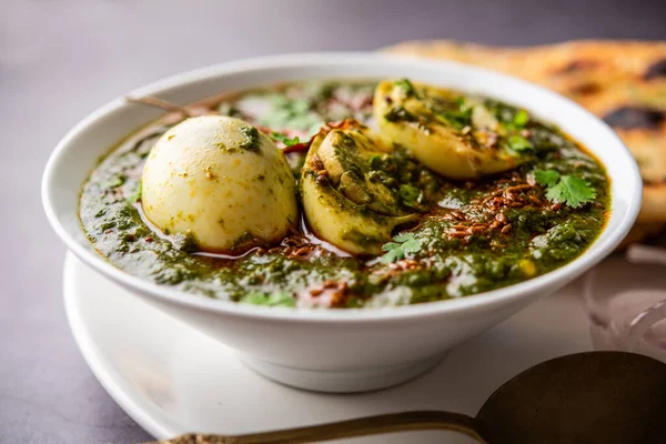 Spinach egg curry is an Indian non vegetarian dish made using palak gravy with eggs