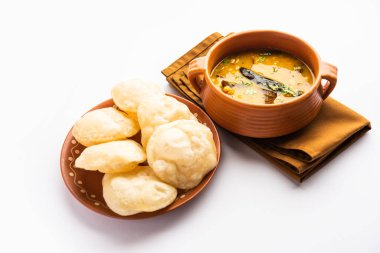 Luchi Cholar Dal or Fried bread made of flour served along with curried Chana or Bengal gram