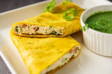 Paneer stuffed Besan chilla or Cheela made using chickpea flour with cottage cheese stuffing