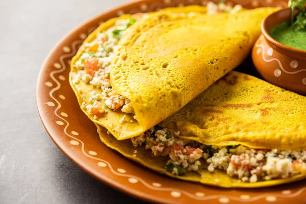 Paneer stuffed Besan chilla or Cheela made using chickpea flour with cottage cheese stuffing