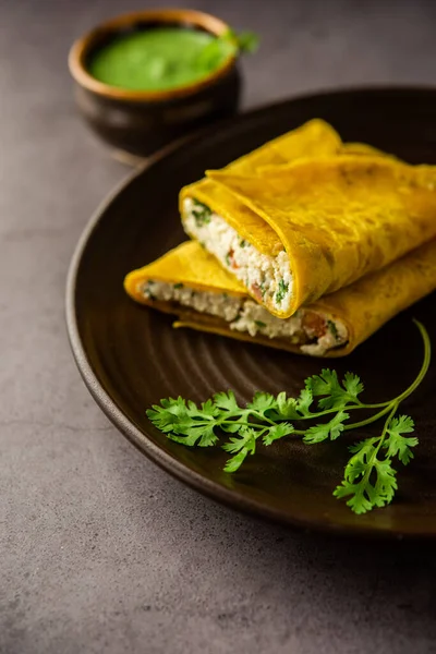 Paneer stuffed Besan chilla or Cheela made using chickpea flour with cottage cheese stuffing