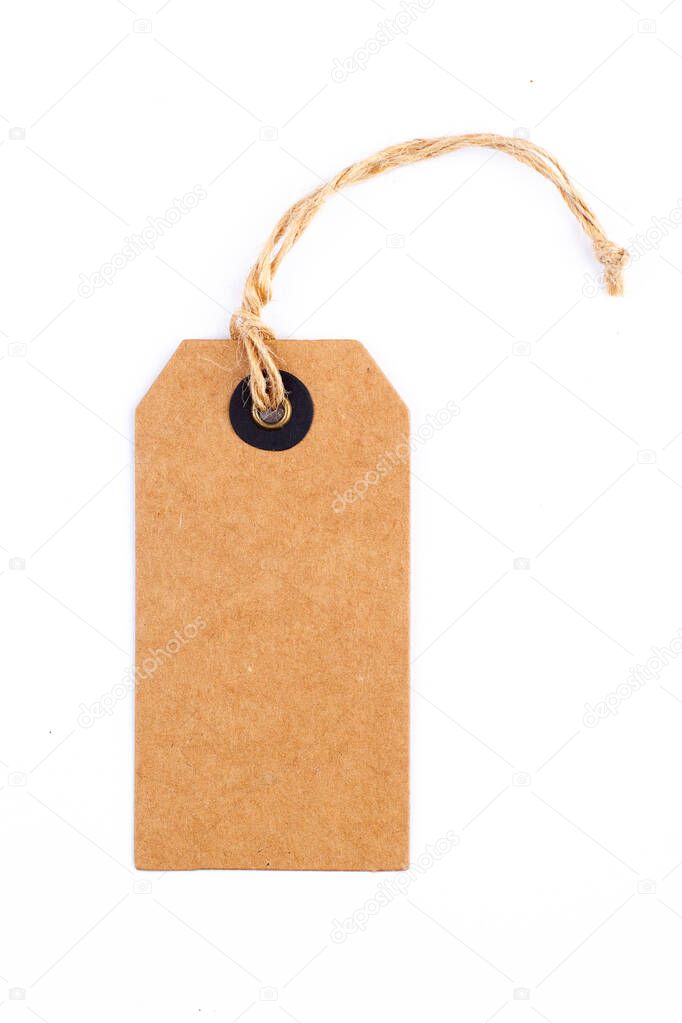 top view closeup of vintage blank craft paper tag with textile thread isolated on white background