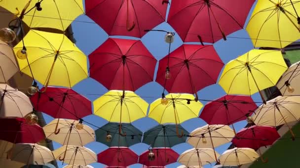 Front View Closeup Detail Colorful Umbrellas Edison Light Bulbs Hanging — Video Stock