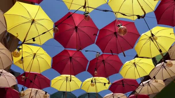 Front View Closeup Detail Colorful Umbrellas Edison Light Bulbs Hanging — Video Stock