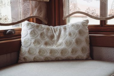 Yastığın ön planı pencerenin önündeki divana nakışla kapatılmış.