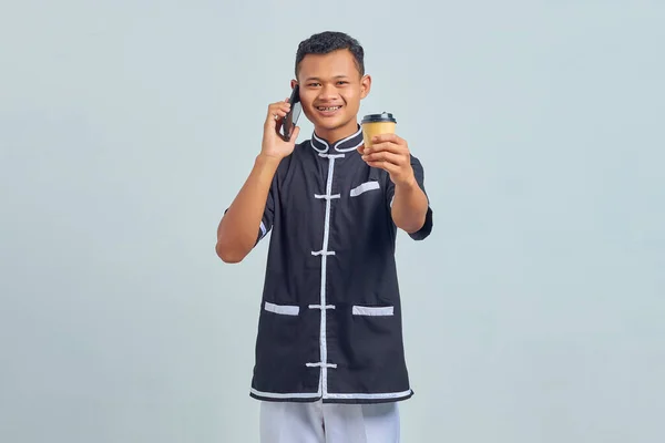 Portrait Smiling Asian Young Man Wearing Karate Uniform Talking Smartphone — Stock Photo, Image