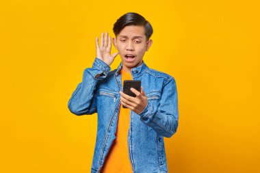 Akıllı telefondan gelen mesajı gören şaşırmış bir adamın portresi