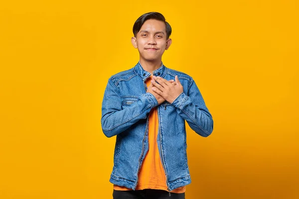 Portrait Smiling Asian Man Hands Chest Isolated Yellow Background — Stock Photo, Image