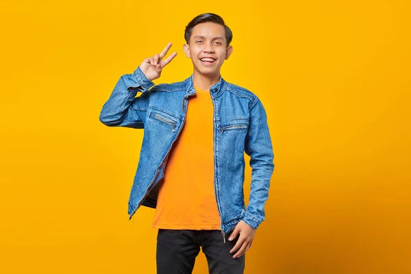 Attraktiver Lächelnder Junger Asiatischer Mann Macht Friedenszeichen Mit Der Hand — Stockfoto