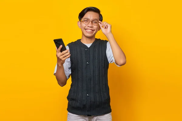 Посмішка Азіатського Чоловіка Торкається Окулярів Тримає Мобільний Телефон Одній Руці — стокове фото