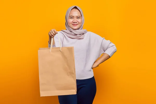 Portrait Cheerful Asian Woman Holding Shopping Bag Yellow Background — Stok Foto