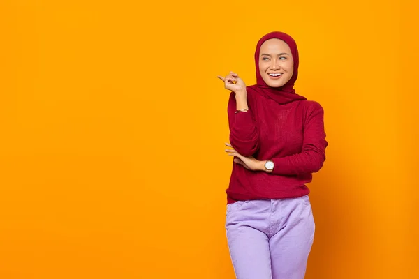Cheerful Asian Woman Pointing Fingers Empty Space Yellow Background — Stock Photo, Image