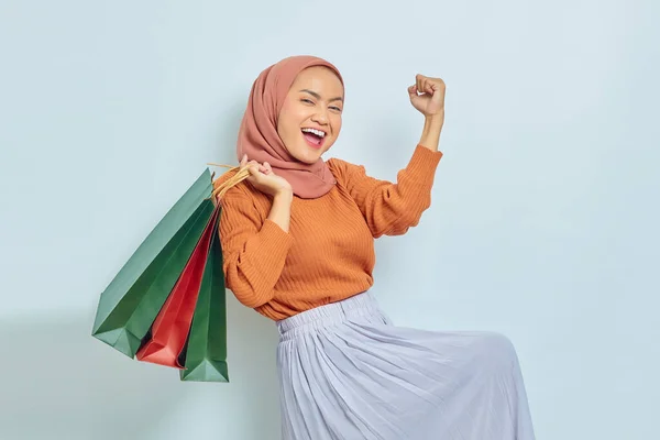 Portrait Excited Asian Muslim Woman Brown Sweater Sunglasses Holding Package — Stok Foto