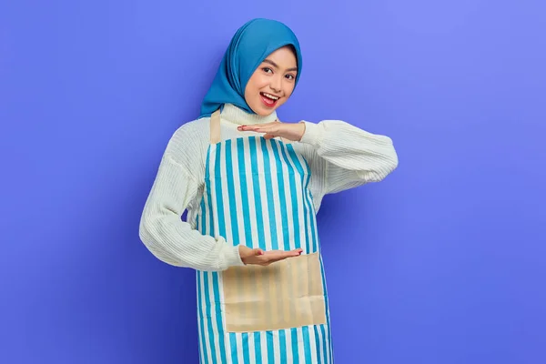 Jovem Mulher Muçulmana Asiática Alegre Hijab Avental Listrado Mostrando Produto — Fotografia de Stock
