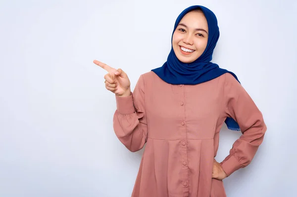 Cheerful Young Asian Muslim Woman Pink Shirt Pointing Fingers Copy — стоковое фото