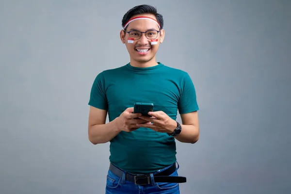 Smiling Young Asian Man Casual Shirt Holding Mobile Phone Looking — Φωτογραφία Αρχείου
