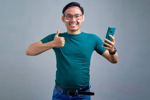 Cheerful Young Asian Man Casual Shirt Holding Mobile Phone Showing — Φωτογραφία Αρχείου