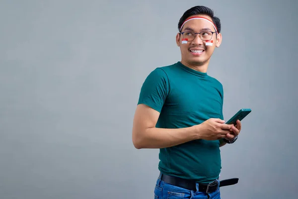 Smiling Young Asian Man Casual Shirt Holding Mobile Phone Looking — Φωτογραφία Αρχείου