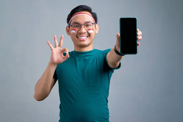 Smiling Young Asian Man Casual Shirt Showing Blank Screen Mobile — Stockfoto