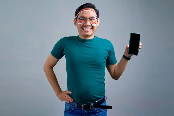 Smiling Young Asian Man Casual Shirt Showing Blank Screen Mobile — Zdjęcie stockowe