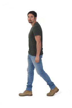 Beyaz arka planda yürüyen ve kameraya bakan yan görüş adamı