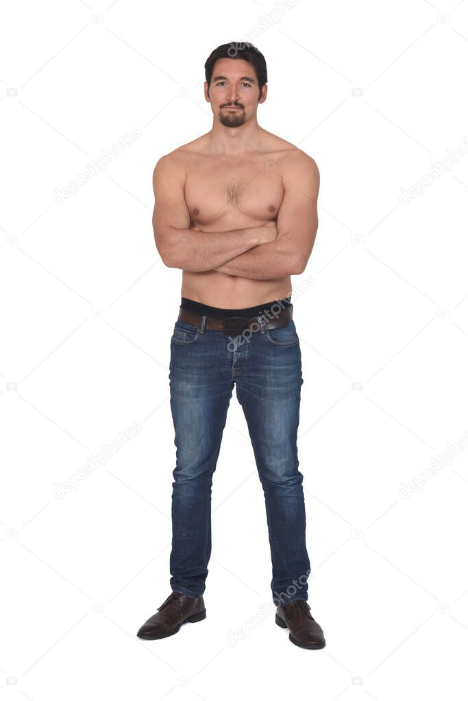 man shirtless and with blue jeans, arms crossed and looking at camera on white background