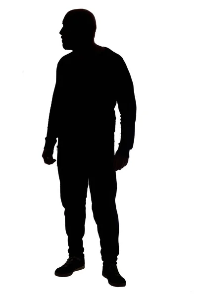 Silhouette Eines Mannes Der Auf Weißem Hintergrund Steht Und Wegsieht — Stockfoto