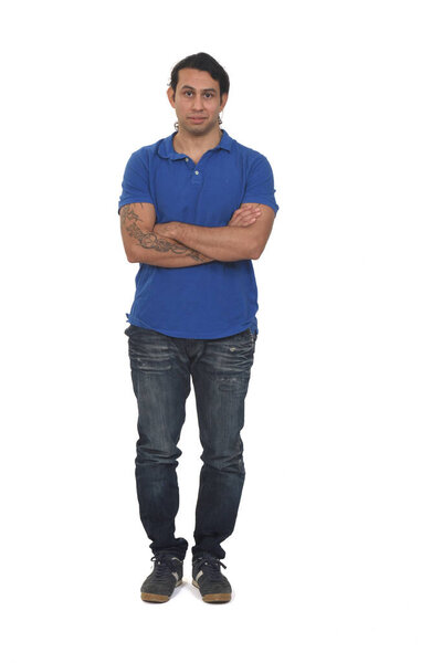 front view of a man with long hair and tattoo arms crossed on white background