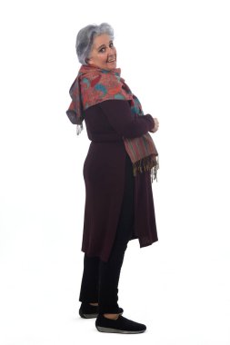 side view of asenior woman looking at camera on white background