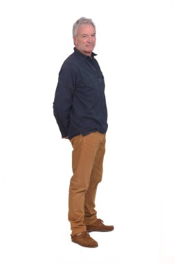 side view of a man hands on back and looking at camera on white background