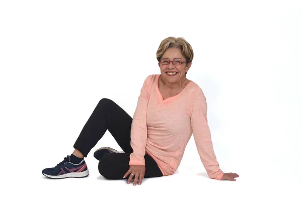 Side View Happy Senior Woman Sitting Floor Looking Camera White — 스톡 사진