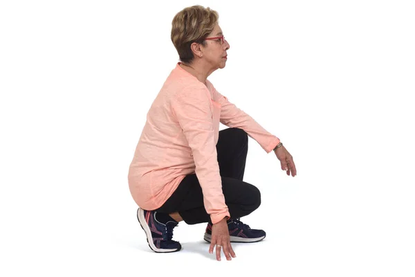 Side View Aserious Senior Woman Squatting White Backgrond — 스톡 사진