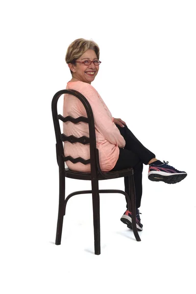 Seated Senior Woman Who Turns Looks Camera White Background — 스톡 사진