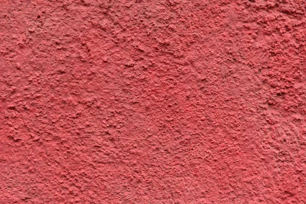 a concrete wall painted with red spray paint