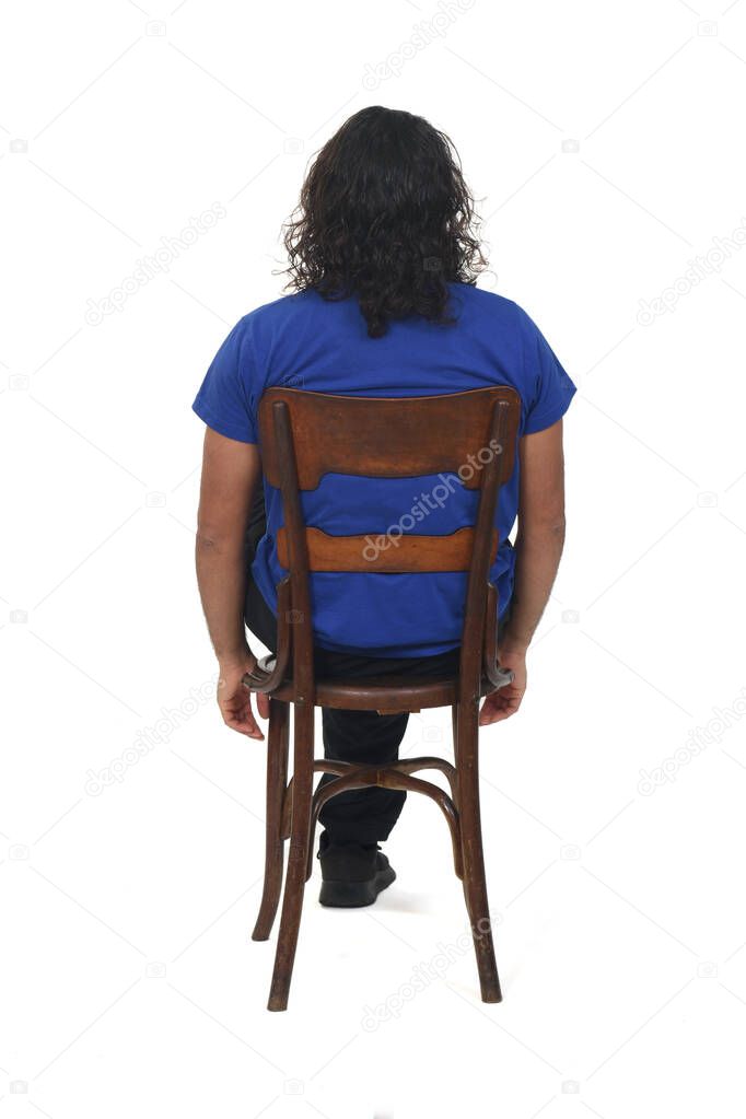 rear view of a man with sportswear sitting on chair on white background