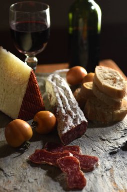 typical spanish food,tomato,wine,bread, cheese and sausage