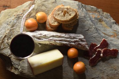 top view of typical spanish food,tomato,wine,bread, cheese and sausage