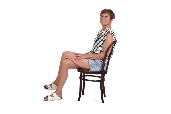 Side View Full Portrait Middle Aged Woman Sitting Chair Legs — kuvapankkivalokuva