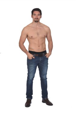 shirtless man with hands on pockets on white background