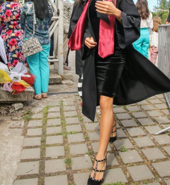 Üniversite mezunu öğrenciler parkta fotoğraf çekimi yapıyorlar.