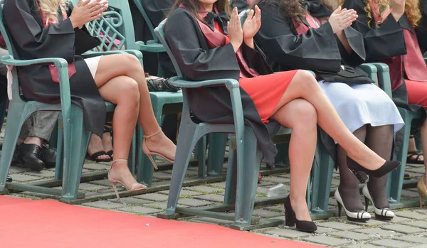 Üniversite mezunu öğrenciler parkta fotoğraf çekimi yapıyorlar.